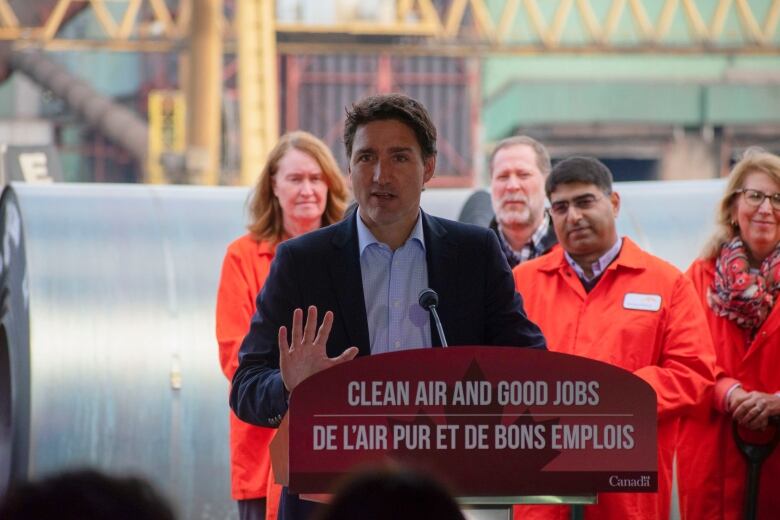 A man stands at a podium