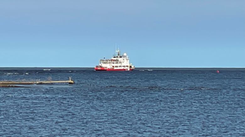 A Canadian Coast Guard vessel is seen on a lake, from a distance.