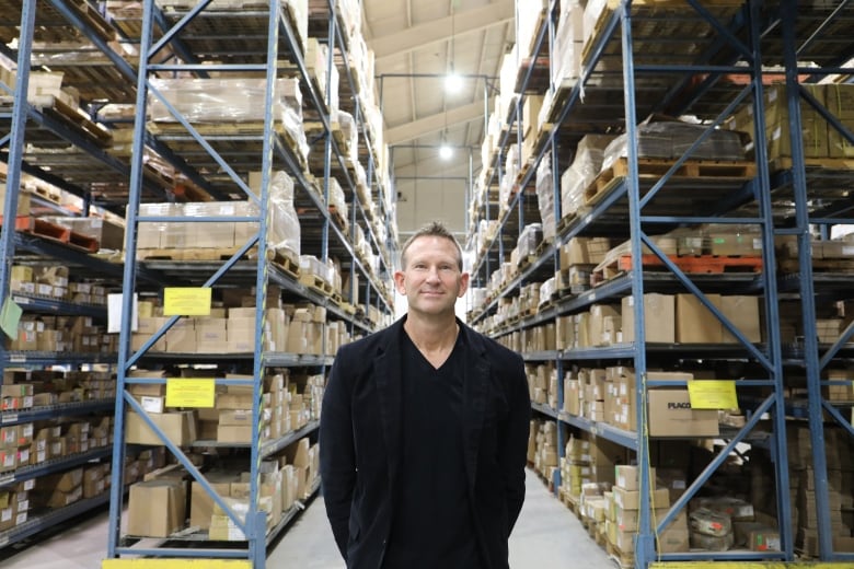 A man standing in a warehouse.