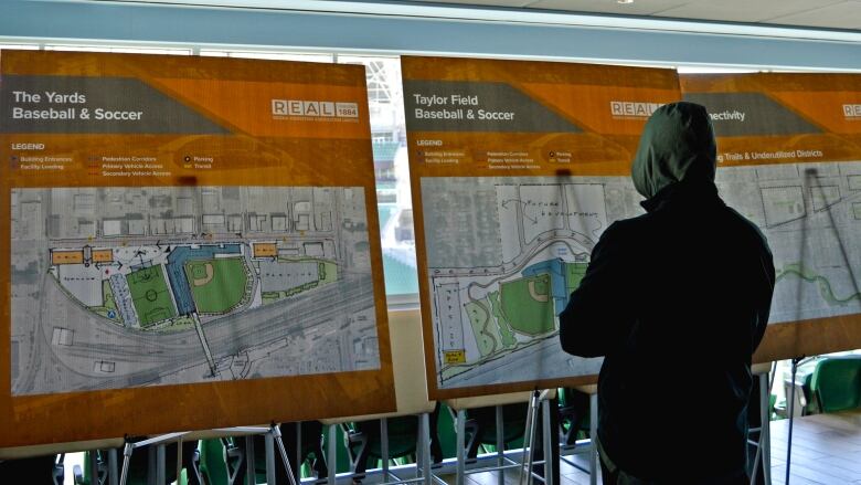 A Regina resident views some of the information boards about five potential projects that could shape the city's downtown for decades to come. 