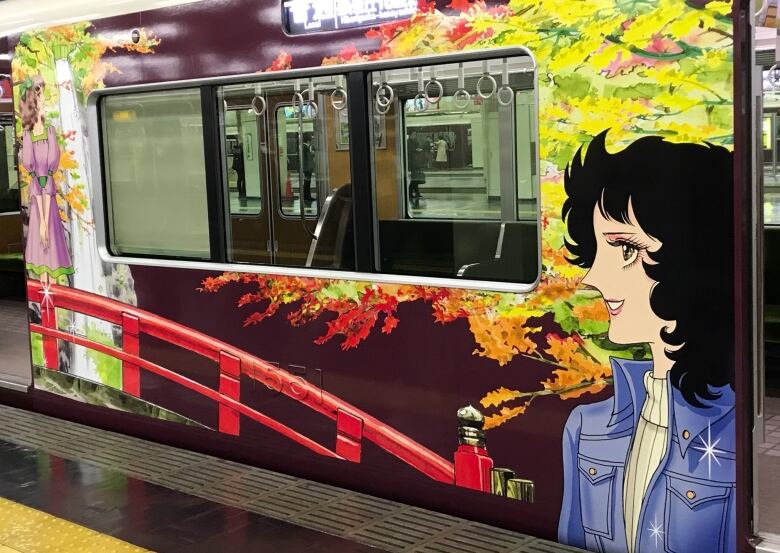 A anime character painted on the outside of a train. 