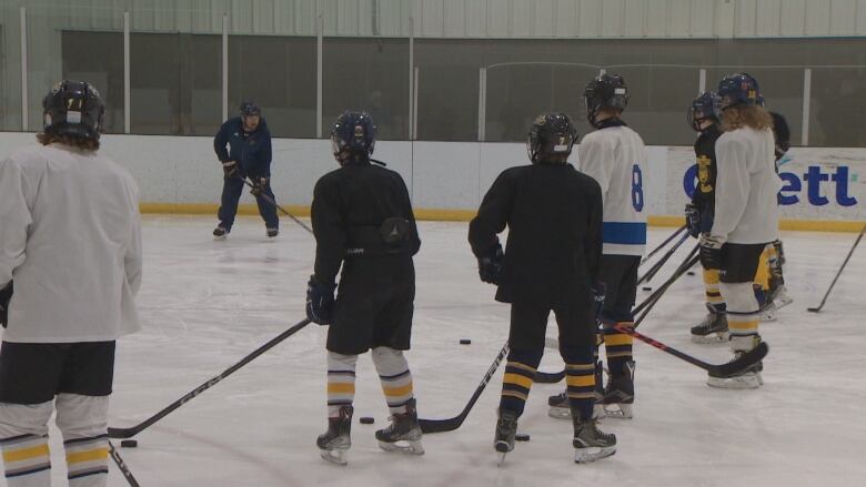 Hockey players on an ice rink. 