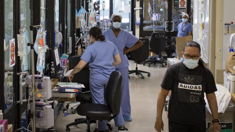 Staff work inside a hospital.