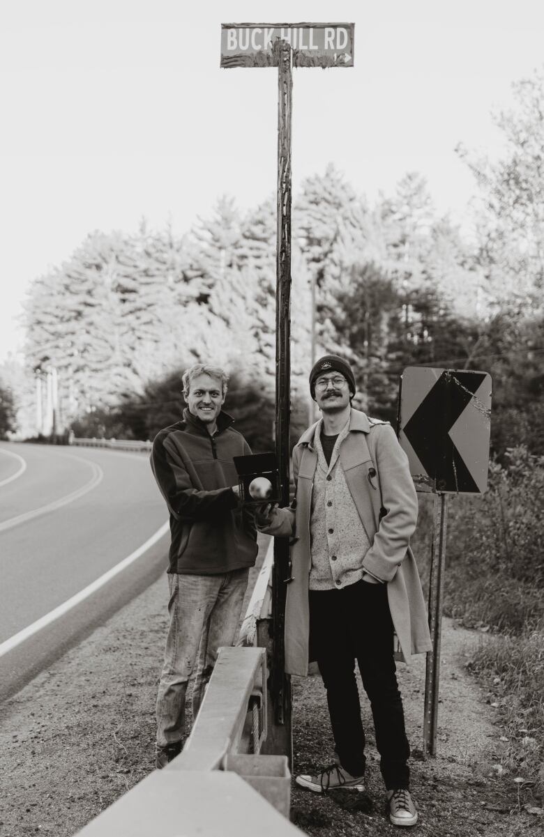 Two people on a rural road.