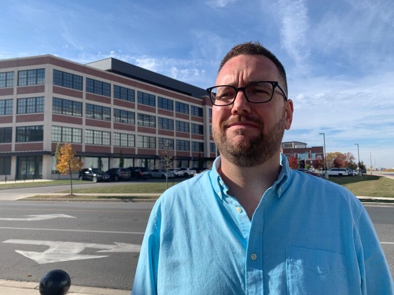 A man standing in front of a building.