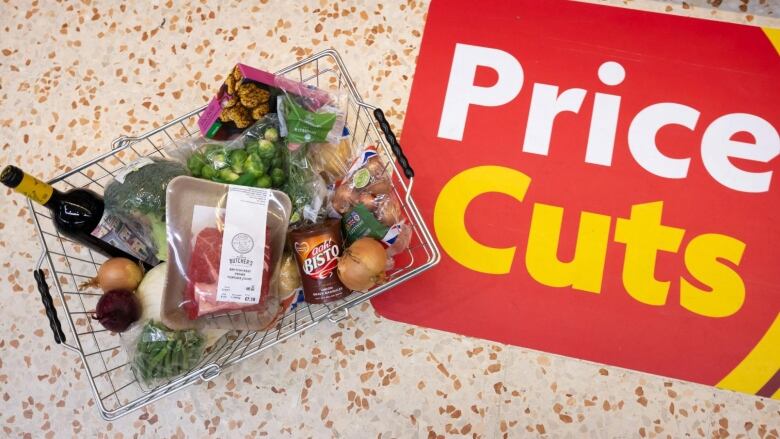 A basket of shopping filled with produce used in a traditional Sunday roast dinner is displayed on October 23, 2022 in Cardiff, Wales. In the basket is meat, gravy, wine and vegetables. 