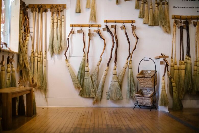 Brooms are picture for sale at the Granville Island Broom Co in Vancouver, British Columbia on Friday, October 28, 2022. 