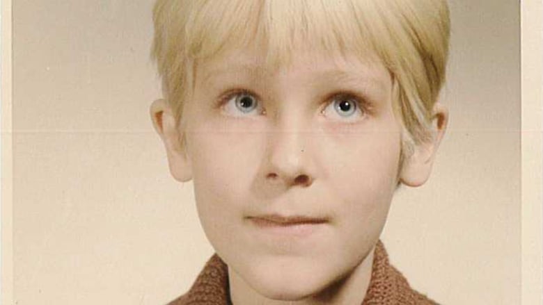 A young girl with short hair in a school photo.