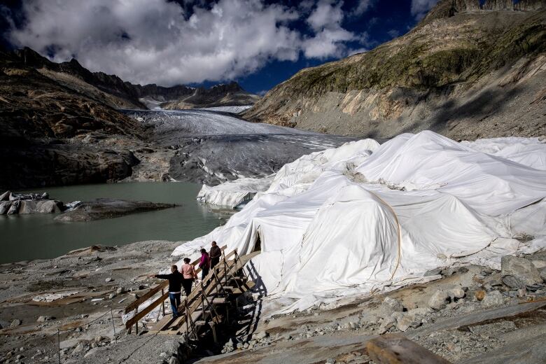 A glacier is covered with plastic to protect it from melting amid warming temperatures.