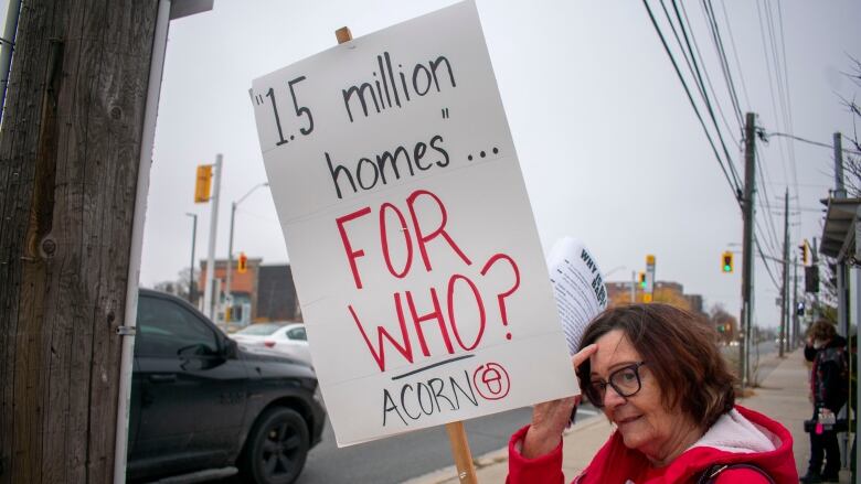 A person holding a sign that says 