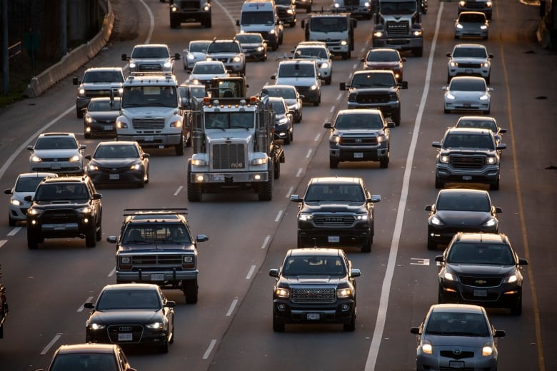 Dozens of cars lined up in traffic.