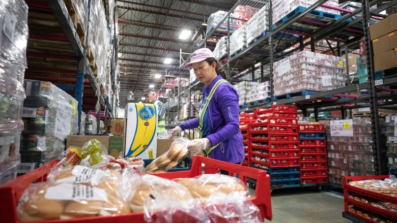  A volunteer sorts food for those in need at the Greater Vancouver Food Bank.