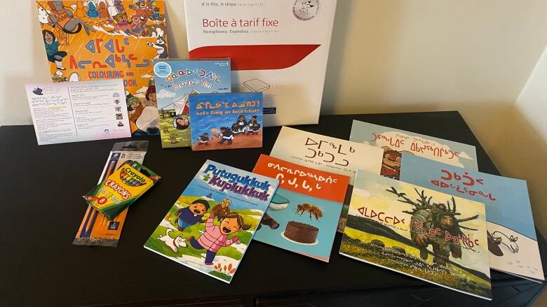 A series of children's books lay on a table.