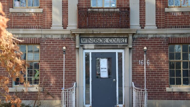 Front doors of an old brown brick building. 