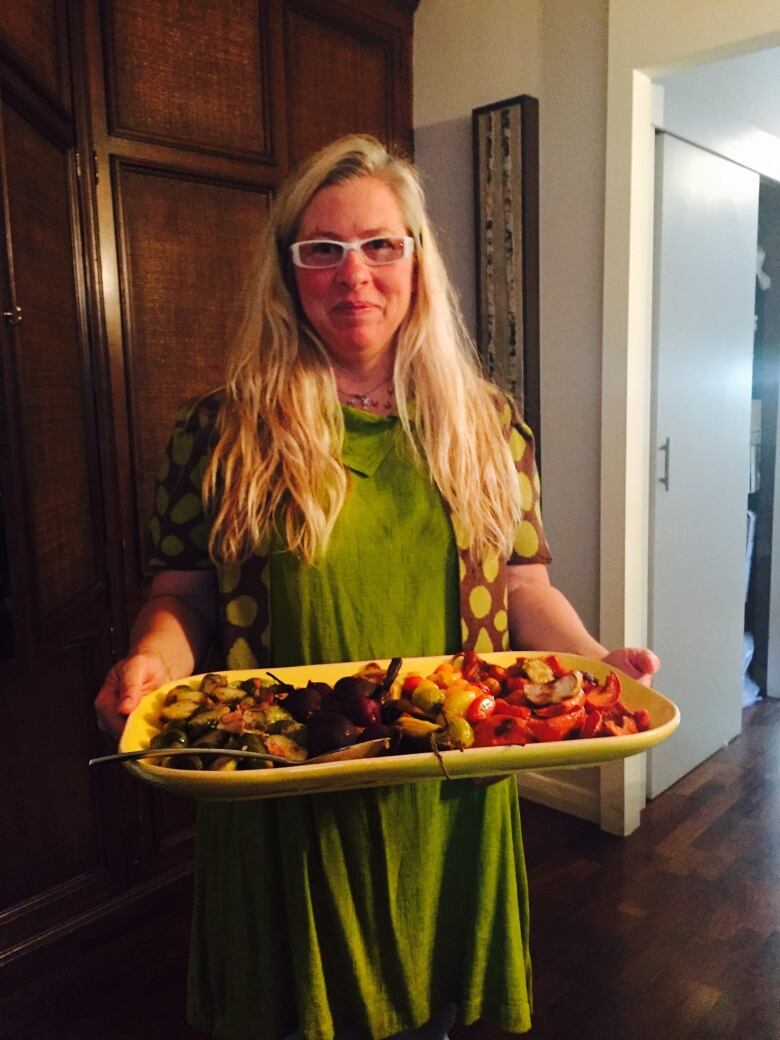 A woman holding a platter.