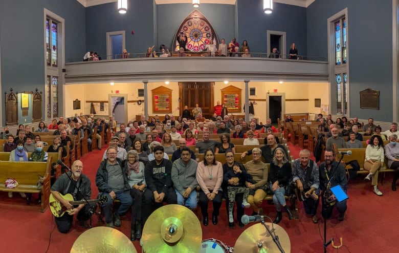 A large group of people are in a church.