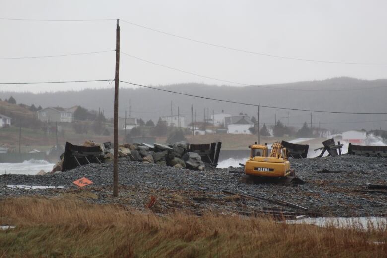 Coast line with debris scattered across a beach. 