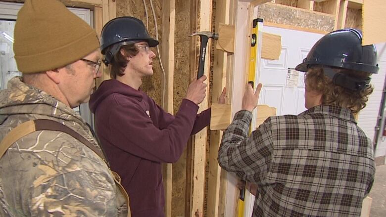 Students working on a door frame.