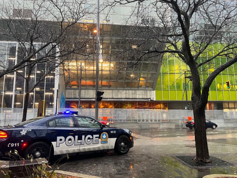 A police car is parked on the sidewalk. 