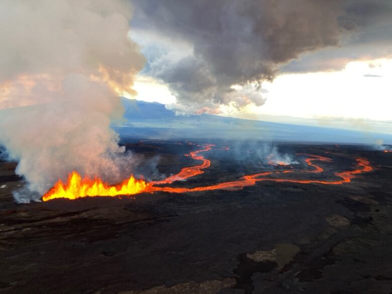 Clouds of smoke coming out of burning rivers of lava.