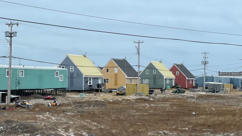 A row of colourful houses with low-hanging roofs on the streets of Rankin Inlet 