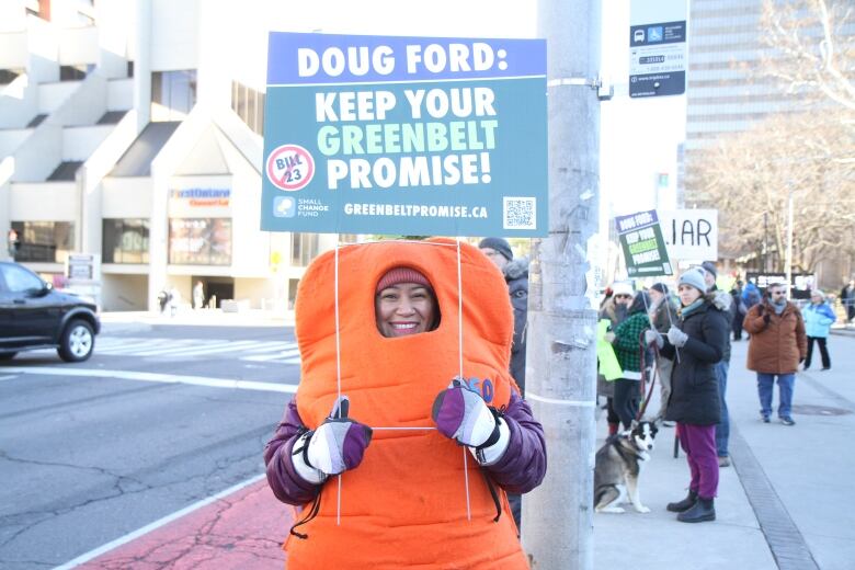 Jessica Bonilla-Damptey said she wanted the carrot costume to draw attention to her signs and spirit of protests, as well as keep her warm during the rally.