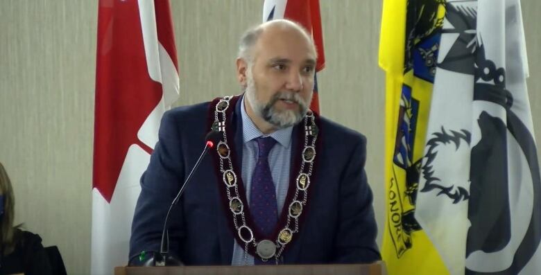 A mayor speaks at a podium.