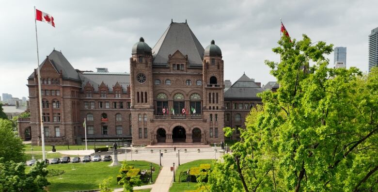 An aerial view showing a government building in the background and trees in the foreground.