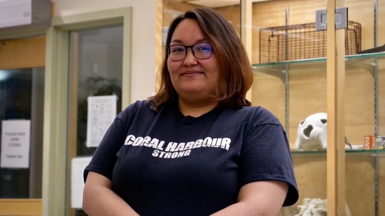 A portrait of a smiling woman in a t-shirt that says Coral Harbour Strong.