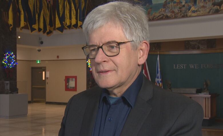 Politician standing in lobby of the Confederation building.