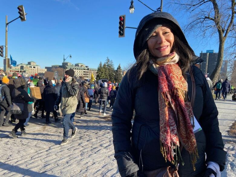 Atossa Soltani smiling in her winter coat and scarf at the protest