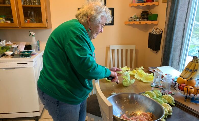 A woman makes cabbage rolls 