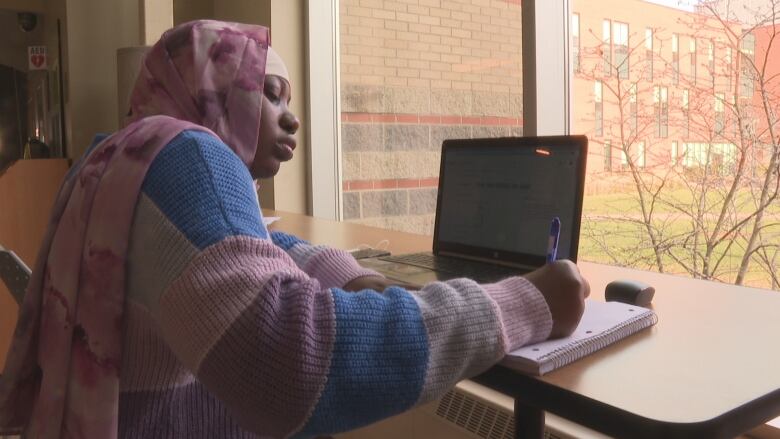 A woman with a lap top computer 