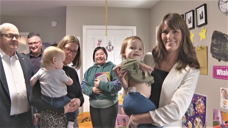 Federal Families Minister Karina Gould and P.E.I. Lifelong Learning Minister Natalie Jameson holding toddlers.