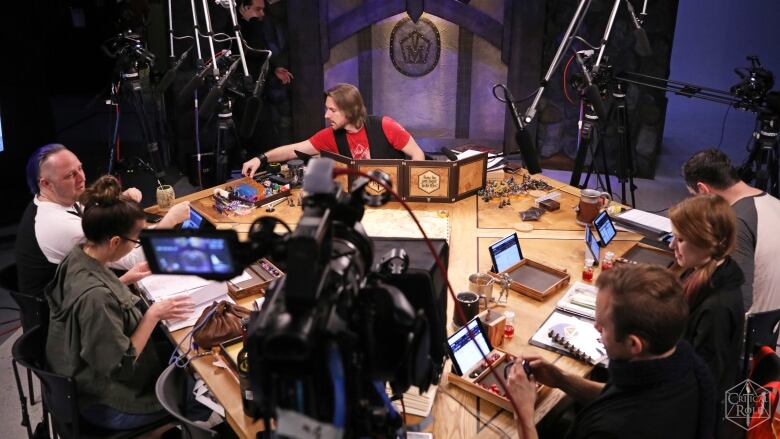 This image shows the production set up with microphones and cameras around a table as the cast prepares to start a stream of Critical Role.