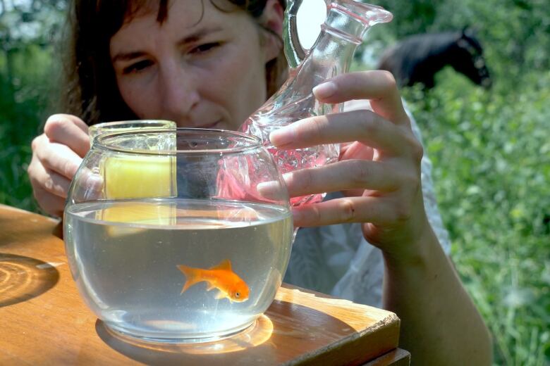 Jenalene Antony behind a goldfish in a bowl.