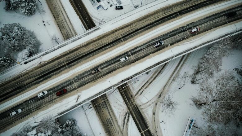 A row of cars drives through Vancouver's Fairview neighbourhood during a major snowfall.