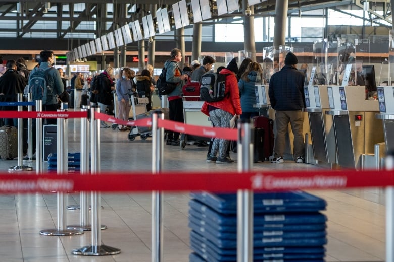 A photo of air travellers checking in at the Ottawa airport. 