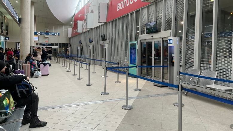 Passengers sit on chairs outside the gates at the bus terminal in downtown Montreal.