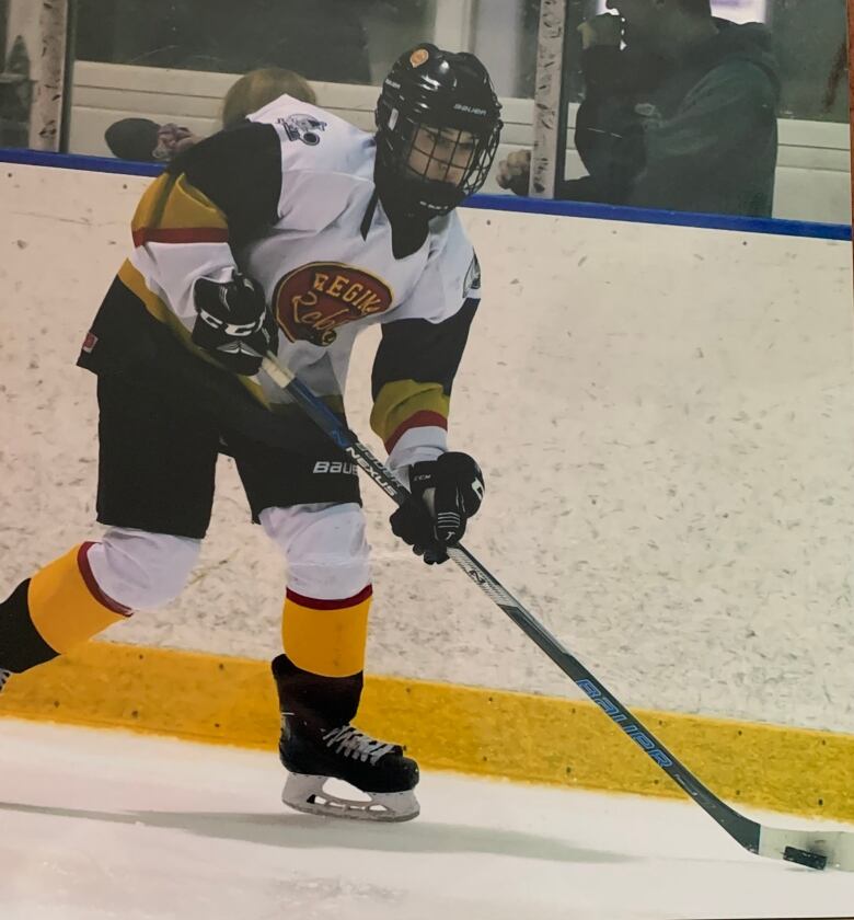 Female hockey player skating with puck