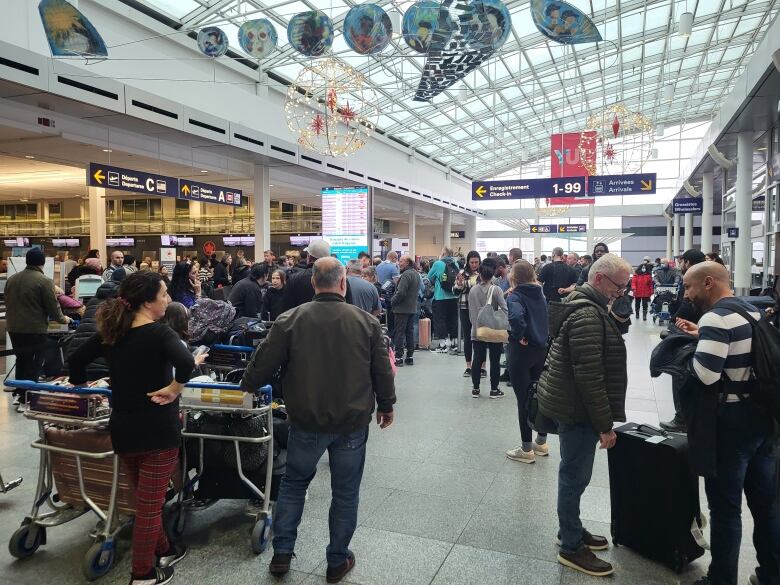 Travellers wait at Montreal aiport.