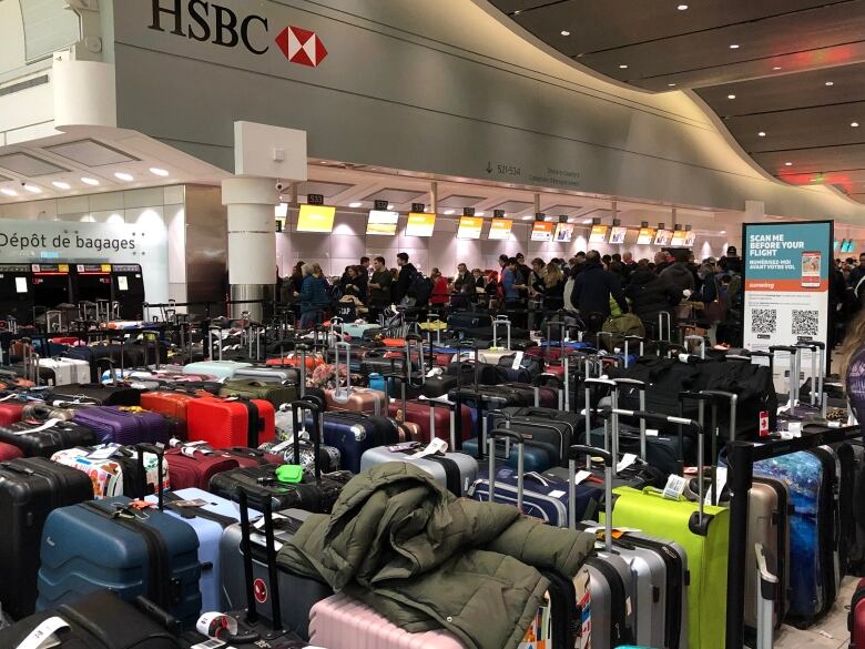 Dozens of suitcases lining Terminal 3 at Pearson airport.