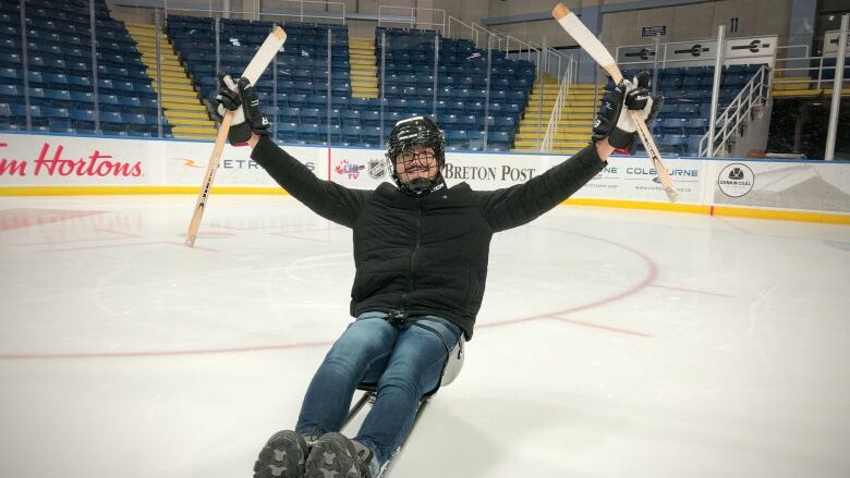 Cape Breton University student Parin Shah from India has a blast trying out sledge hockey at Sydney's Centre 200 arena.