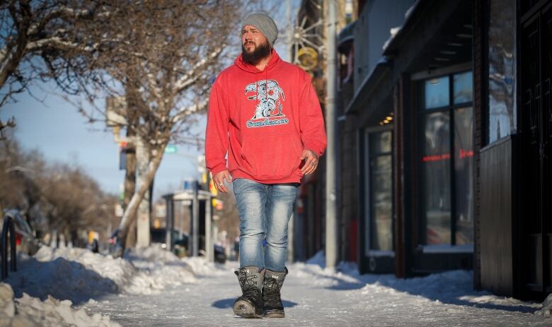 A man walks down a street.