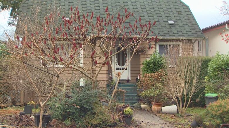 A brown East Vancouver house with a green ceiling is pictured. 