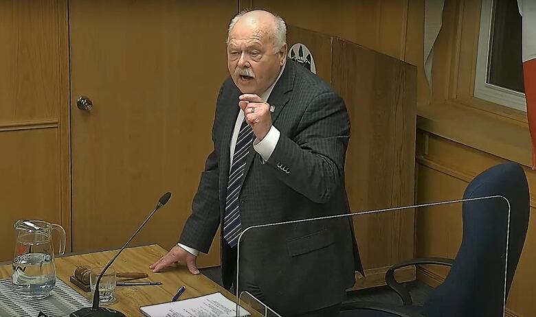 A man at a council chamber.