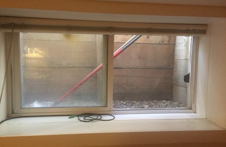 A small egress window in a basement suite.