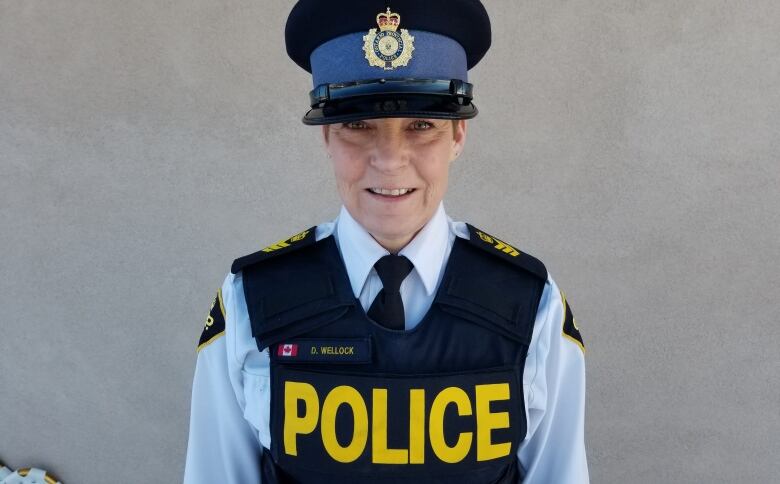 A police officer wears her Ontario Provincial Police uniform and top.