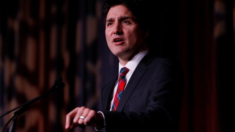 A politician points downward during a speech.