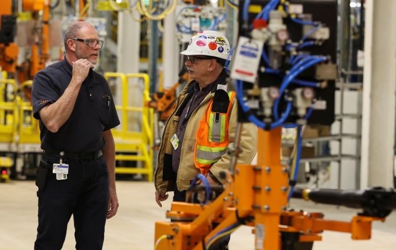 Employees talk at automaker General Motors (GM) Brightdrop unit's CAMI EV Assembly, Canada's first full-scale electric vehicle manufacturing plant, in Ingersoll, Ontario, Canada December 5, 2022.  REUTERS/Carlos Osorio